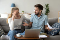 Stressed unhappy couple arguing about expenses